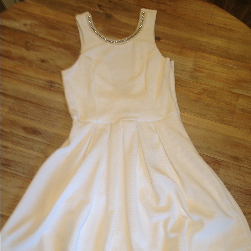 White dress with pearl and rhinestone detailing.